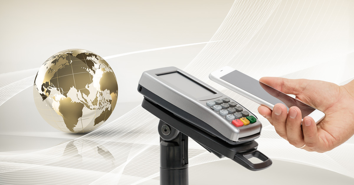 A hand reaches out to use their mobile device to make a payment using a point of sale machine.